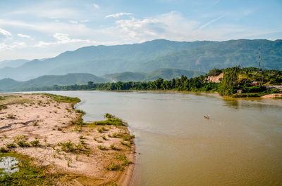 Scenic view of lake and mountains against sky