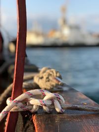 Close-up of rusty rope against sea