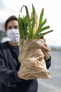 Close-up of man holding plant