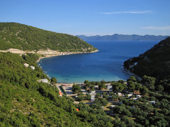 High angle view of townscape by sea against sky