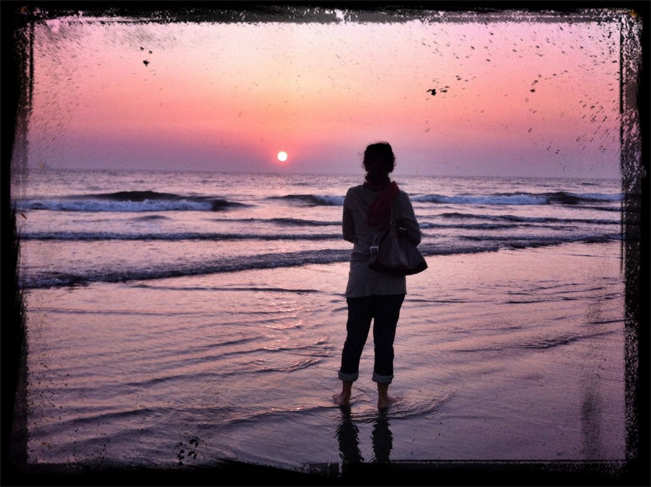 sunset, sea, beach, horizon over water, shore, water, standing, lifestyles, full length, leisure activity, transfer print, sky, silhouette, rear view, sun, orange color, scenics, sand