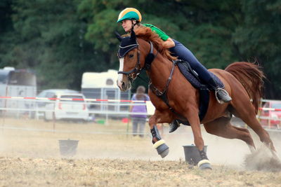 A girl and her horse  in action during a mounted games competition 