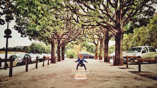 Rear view of man walking on road