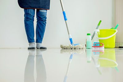 Low section of man cleaning floor 