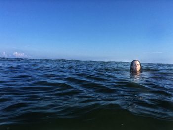 Scenic view of sea against blue sky