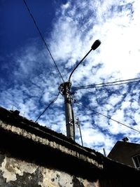 Low angle view of telephone pole against sky