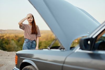 Side view of woman holding car