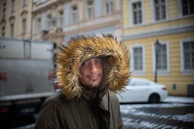 Portrait of hipster man in fur coat