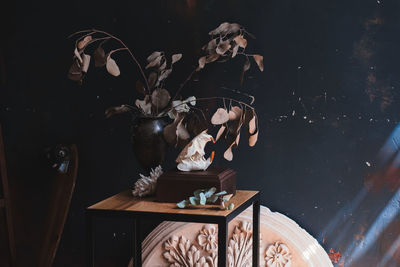 Digital composite image of man and woman sitting on table