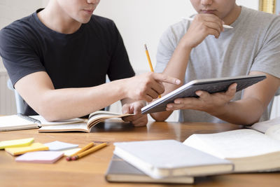 Young students campus helps friend catching up and learning.