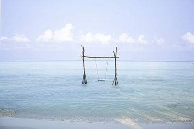 Lifeguard hut on sea against sky