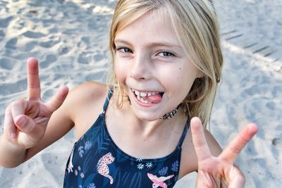 Portrait of smiling girl gesturing at beach