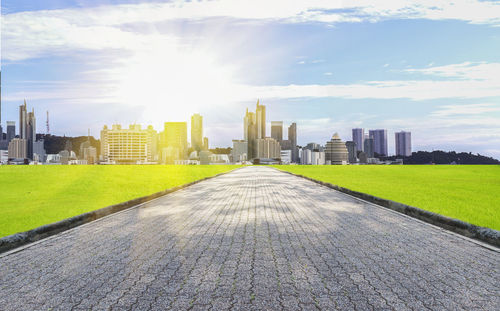 View of city buildings against cloudy sky