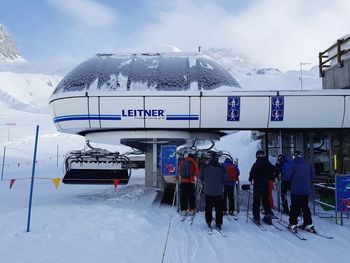 People in snow against sky