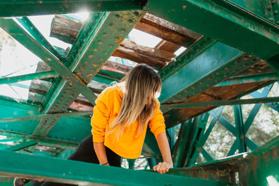 Rear view of woman standing by railing