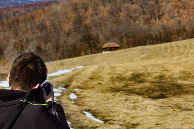 Boy photographing trees