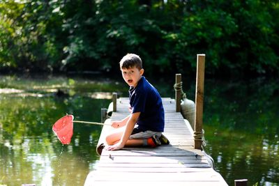 Portrait of boy fishing in lake