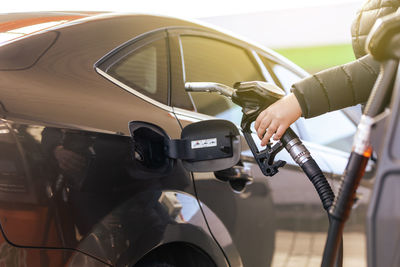 Cropped hand of man holding car