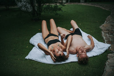 Young couple lying on grass