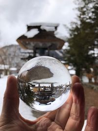 Close-up of hand holding crystal ball