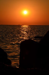 Scenic view of sea against orange sky