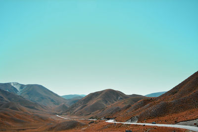 Scenic view of mountains against clear blue sky