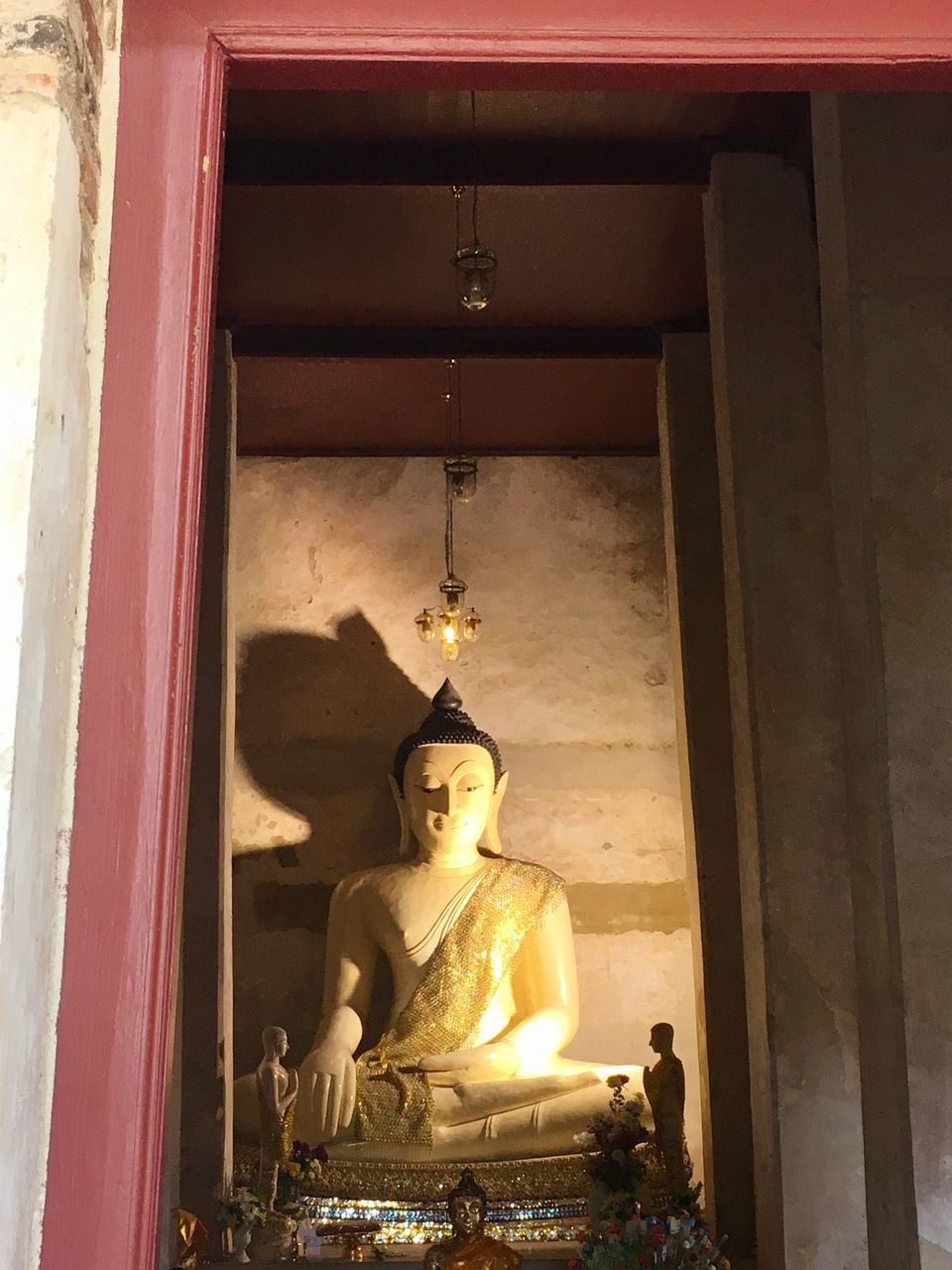 LOW ANGLE VIEW OF BUDDHA STATUE AGAINST TEMPLE