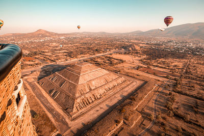 Aerial view of hot air balloon flying over landscape