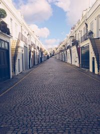Empty road with buildings in background