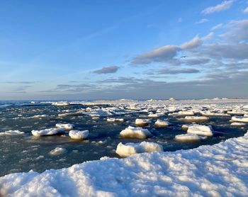 Scenic view of frozen lake against sky