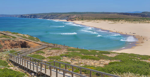 Praia de bordeira beautiful beach and wooden foothpath going to the seaside algarve, portugal