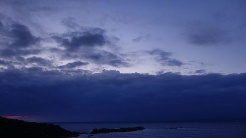 Scenic view of sea against cloudy sky