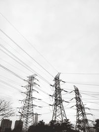 Low angle view of electricity pylon against sky