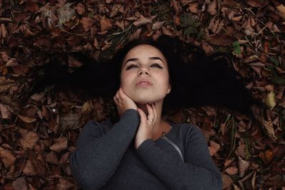 High angle view of beautiful woman lying no field during autumn