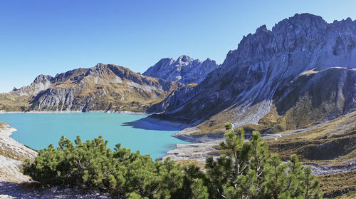 Scenic view of mountains against clear blue sky