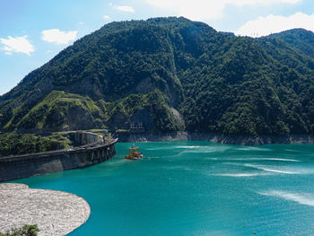 Scenic view of sea and mountains against sky