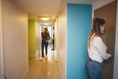 Women standing in corridor of building