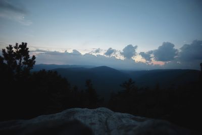 Scenic view of silhouette mountains against sky during sunset