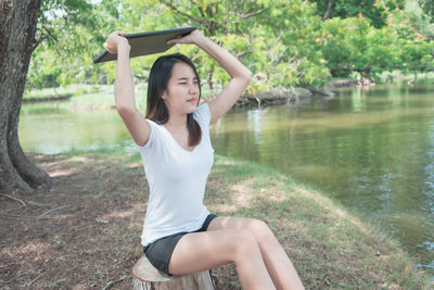 Young woman sitting in park