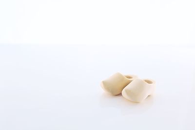 Close-up of bread over white background