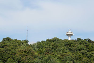 Low angle view of communications tower against sky