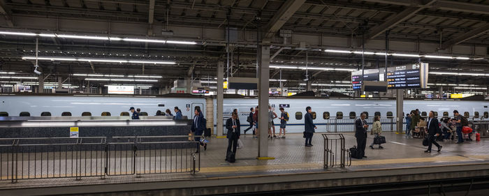 People walking on railroad station platform