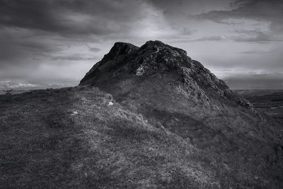 Low angle view of rocky mountain against sky