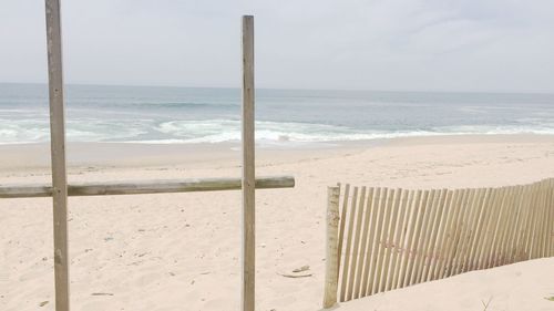 Wooden fence at sandy beach