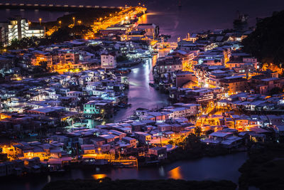 High angle view of illuminated buildings in city at night