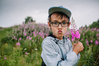 Portrait of man wearing eyeglasses on field