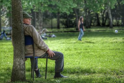 Rear view of man sitting in park