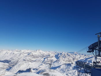 Snow covered mountain against blue sky