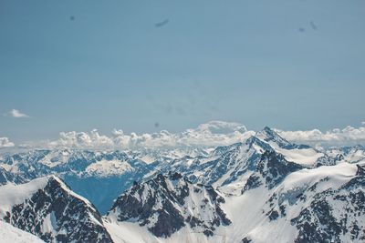 Scenic view of snowcapped mountains against blue sky