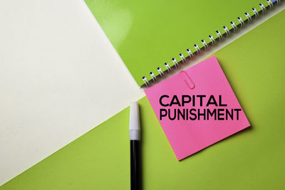 Capital punishment text on adhesive note